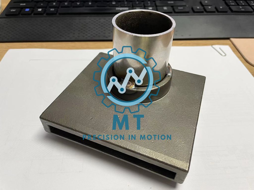 Precision cast steel housing with welded stainless steel bushing